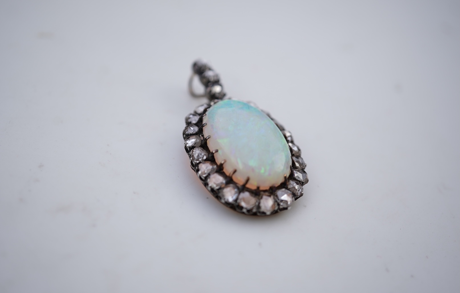 An opal and diamond pendant, early 20th century
